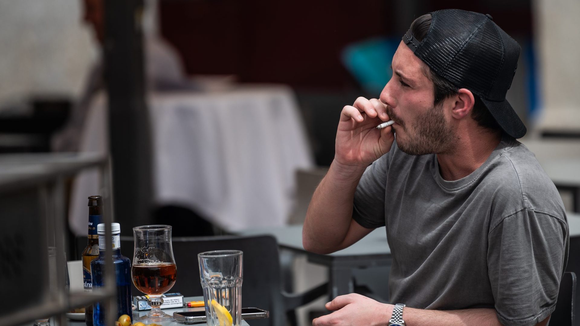 A man smokes on a terrace in Madrid – but maybe not for much longer. Photo: Marcos del Mazo/LightRocket/Getty