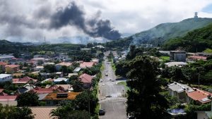 Smoke rises in Nouméa on May 14 amid protests by independence activists in the overseas French territory of New Caledonia. Photo: Théo Rouby/AFP/Getty