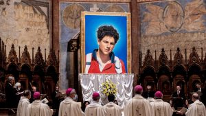 A tapestry featuring a portrait of Carlo Acutis hangs at the St Francis Basilica in Assisi. Photo: Vatican Pool/Getty