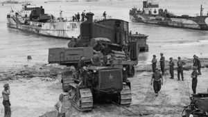 A locomotive is pulled ashore from a landing craft by a tractor at Courseulles-sur-Mer, Normandy, on July 26, 1944, following the D-day landings. Photo: Archive Photos/Getty