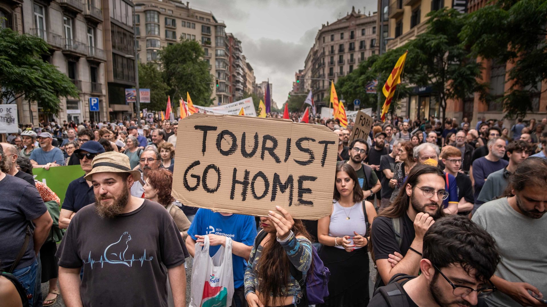 An anti-tourism placard is seen in the center of the demonstration. Photo: Paco Freire/SOPA Images/LightRocket via Getty Images 