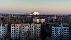 Derelict blocks of flats are overshadowed by the huge curve of the protective cover built to prevent further radiation leaks. All photos: Pierpaolo Mittica