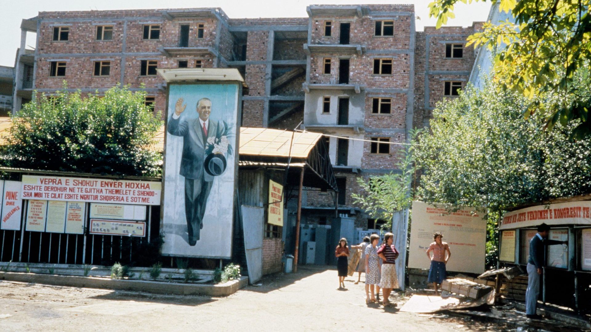 A giant portrait of the late Albanian leader Enver Hoxha near a propaganda poster in Tirana, September 1985. Photo: Georges Gobet/AFP/Getty