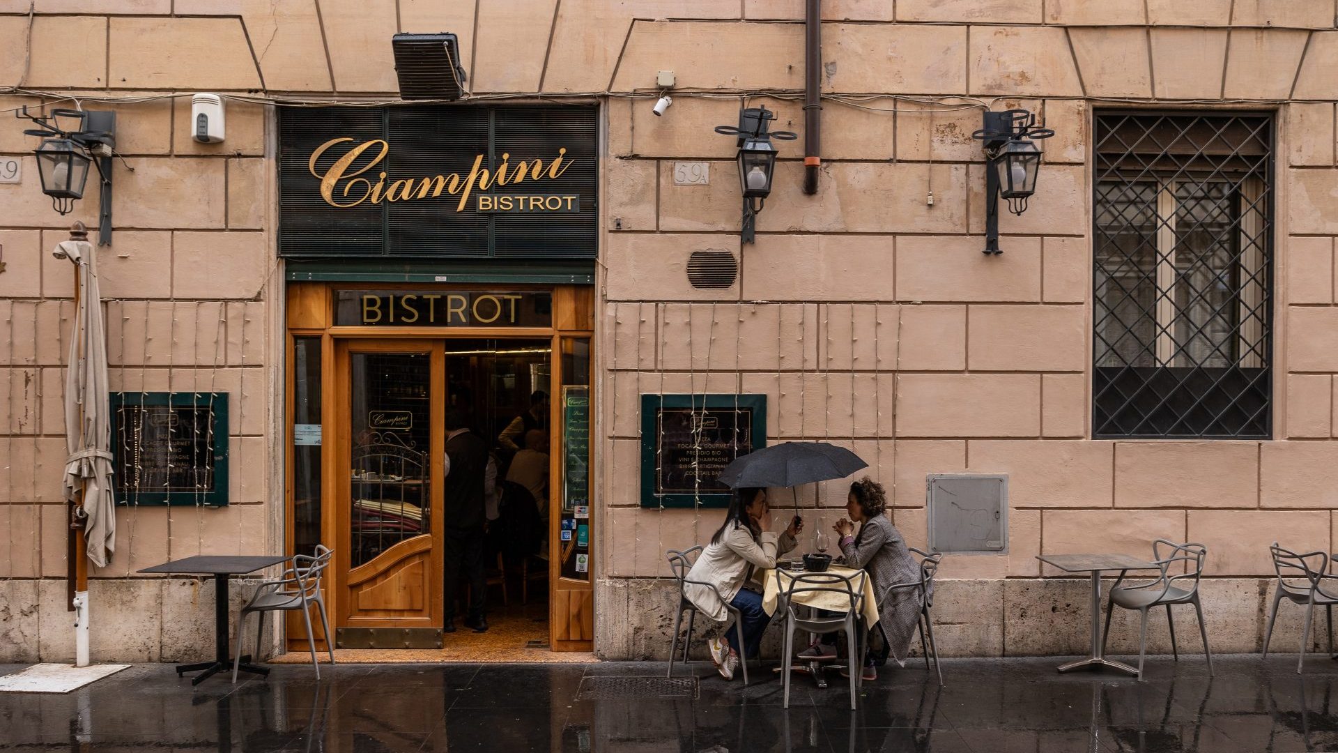 Two women sit at an outdoor table at a cafe in Rome, where they are unlikely to be discussing British politics. Photo: Emanuele Cremaschi/Getty