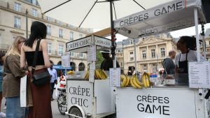 People order crêpes from street-side food carts in Paris on July 11, 2024. Photo: Emmanuel Dunand/AFP/Getty