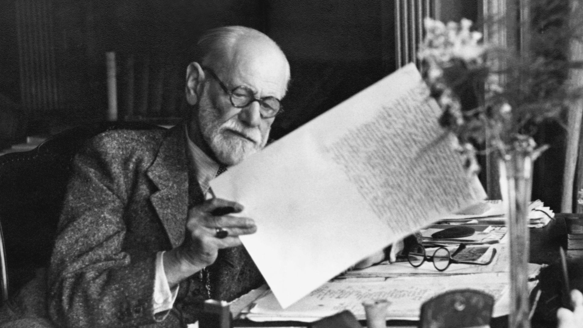 Austrian psychiatrist, in the office of his Vienna home looking at a manuscript. Photo: Getty Images