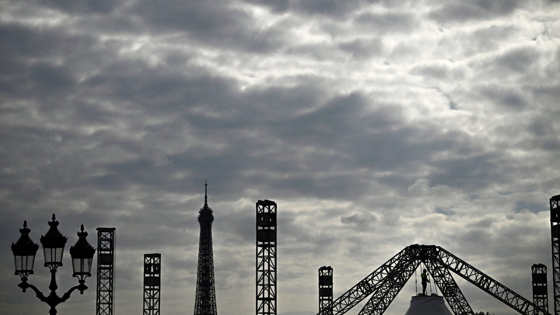 A worker sets up a marquee at the construction site of La Concorde Urban Parc for the Paris 2024 Olympics. Photo: Julien de Rosa/AFP/Getty