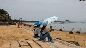 Tourists sit near anti-landing spikes on the beach at Xiamen, in Taiwan’s Kinmen Islands. The spikes are a reminder of the conflict decades earlier with Chinese communist forces. Photo: I-Hwa Cheng/AFP/Getty