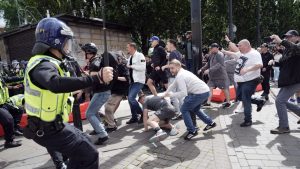 Police clash with right wing protesters in Piccadilly Gardens, Manchester, on August 3 after misinformation spread on social media fuelled acts of violence from far right sympathisers across England. Photo: Christopher Furlong/Getty