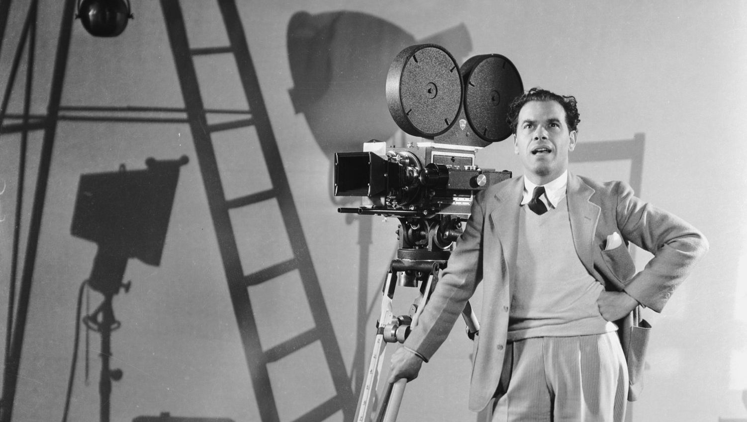 Director Frank Capra stands by a camera on a Columbia productions set, circa 1935. Photo: John Kobal Foundation/Getty