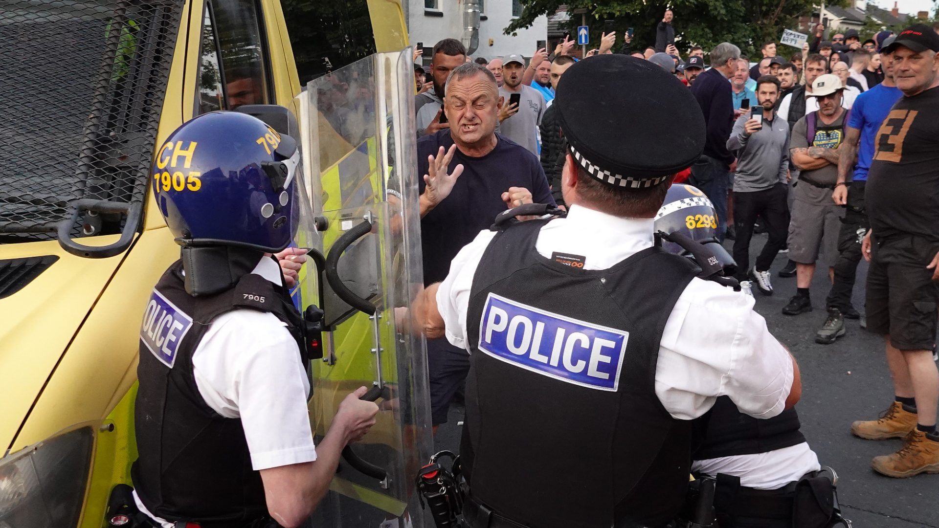 Riot police hold back protesters after disorder breaks out on July 30 in Southport. Photo: Getty