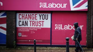 A senior citizen passes a Labour 2024 election campaign shop in Crewe. Around 10 million pensioners will lose the £200-£300 winter fuel allowance this year. Photo: Christopher Furlong/Getty