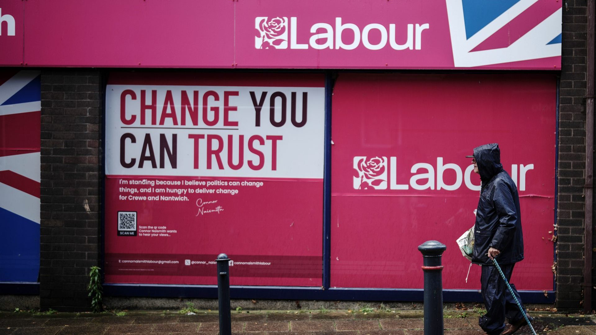 A senior citizen passes a Labour 2024 election campaign shop in Crewe. Around 10 million pensioners will lose the £200-£300 winter fuel allowance this year. Photo: Christopher Furlong/Getty