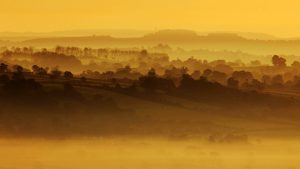 The autumn sun begins to rise over the morning mist on the Somerset Levels near Glastonbury. Photo:
Matt Cardy/Getty