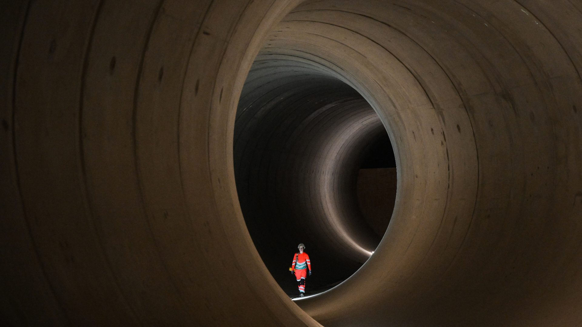 A civil engineer walks inside a seven-metre diameter concrete tunnel at the Thames Tideway building site in west London. With the size of the population set to continue to swell, the need for a £4.3bn sewerage upgrade has become critical. Photo: Daniel Leal/AFP/Getty