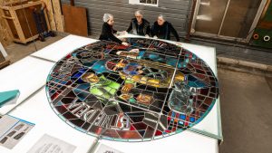 Members of the Vitrail-France workshop restore the rose of the Credo by Jean Hébert-Stevens in April 2024. Photo: Corentin Péchiné