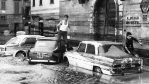 Men clamber over submerged cars in the city following the devastating events of November 4, 1966. Photo: Keystone-France/Gamma-Rapho/Getty