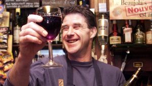 A barman at the French House pub in Soho raises a glass for Beaujolais Nouveau day in November 1999. Photo: Gerry Penny