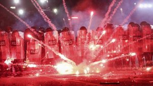 Fireworks fired by protesters explode along police lines outside Georgia’s parliament in Tbilisi. Photo: Giorgi Arjevanidze/AFP/Getty