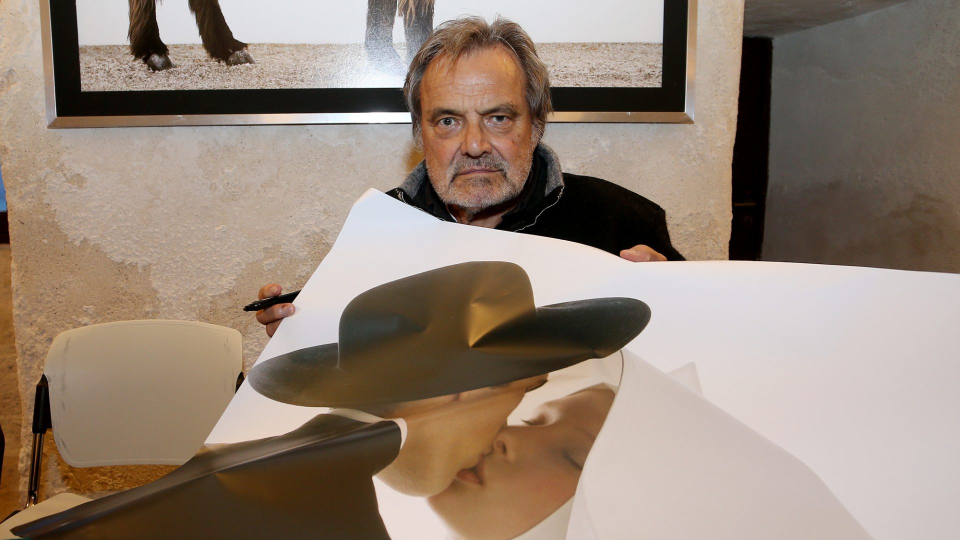 Photographer Oliviero Toscani with a copy of his pictures of a priest and a nun kissing. Toscani died on January 13 at the age of 82. Photo: Donato Fasano/Getty