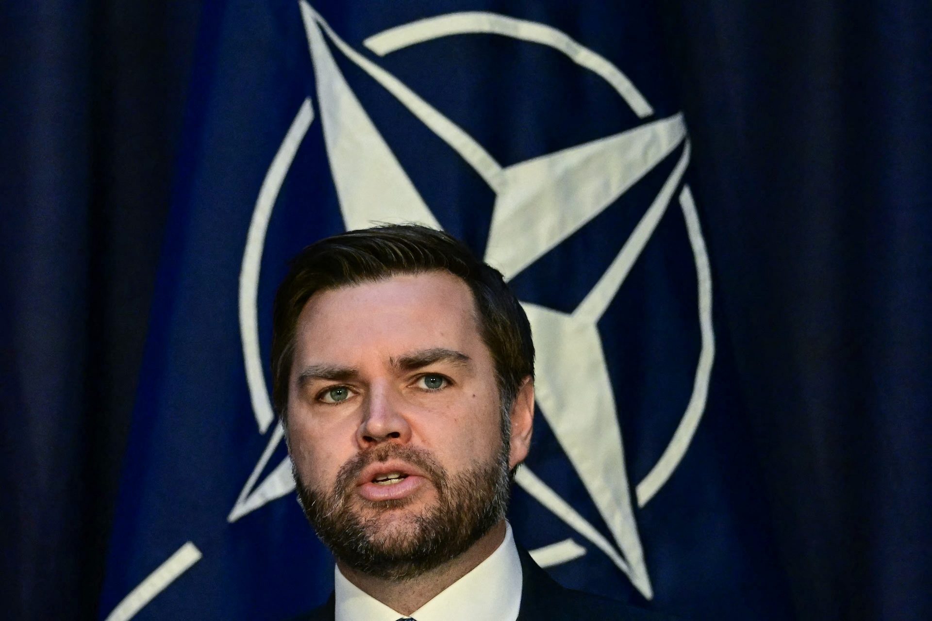 US vice president JD Vance in front of the NATO flag during his disastrous trip to the Munich Security Conference on February 14, 2025. Photo: Tobias Schwarz/AFP