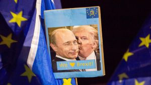 A prescient poster from a 2020 anti-Brexit protest in Edinburgh depicting Donald Trump cosying up to Vladimir Putin. Photo: Robert Perry/Getty