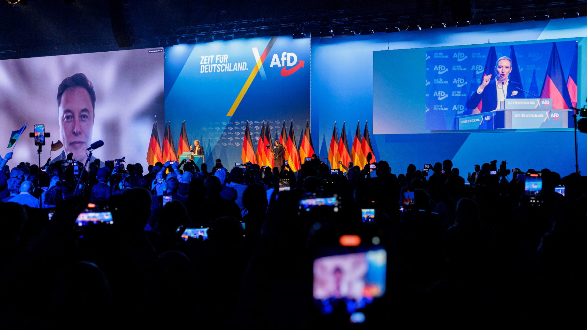 US tech billionaire Elon Musk is seen on a large screen as Alice Weidel, co-leader of Germany’s far right AfD, addresses an election campaign rally in Halle on January 25. Photo: AFP/Getty