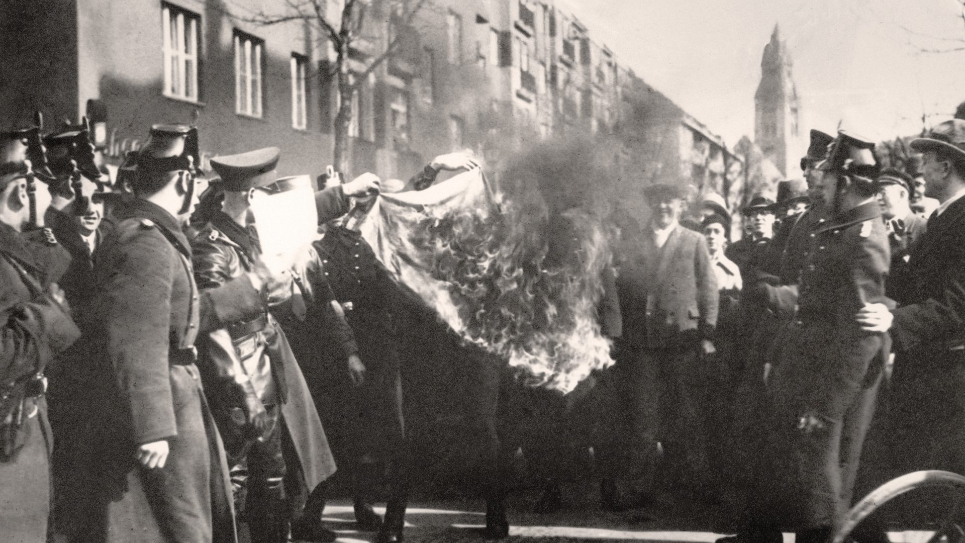 Berlin police publicly burn red flags after raiding the homes of Communists. Germany, 1933. Photo: Bettmann